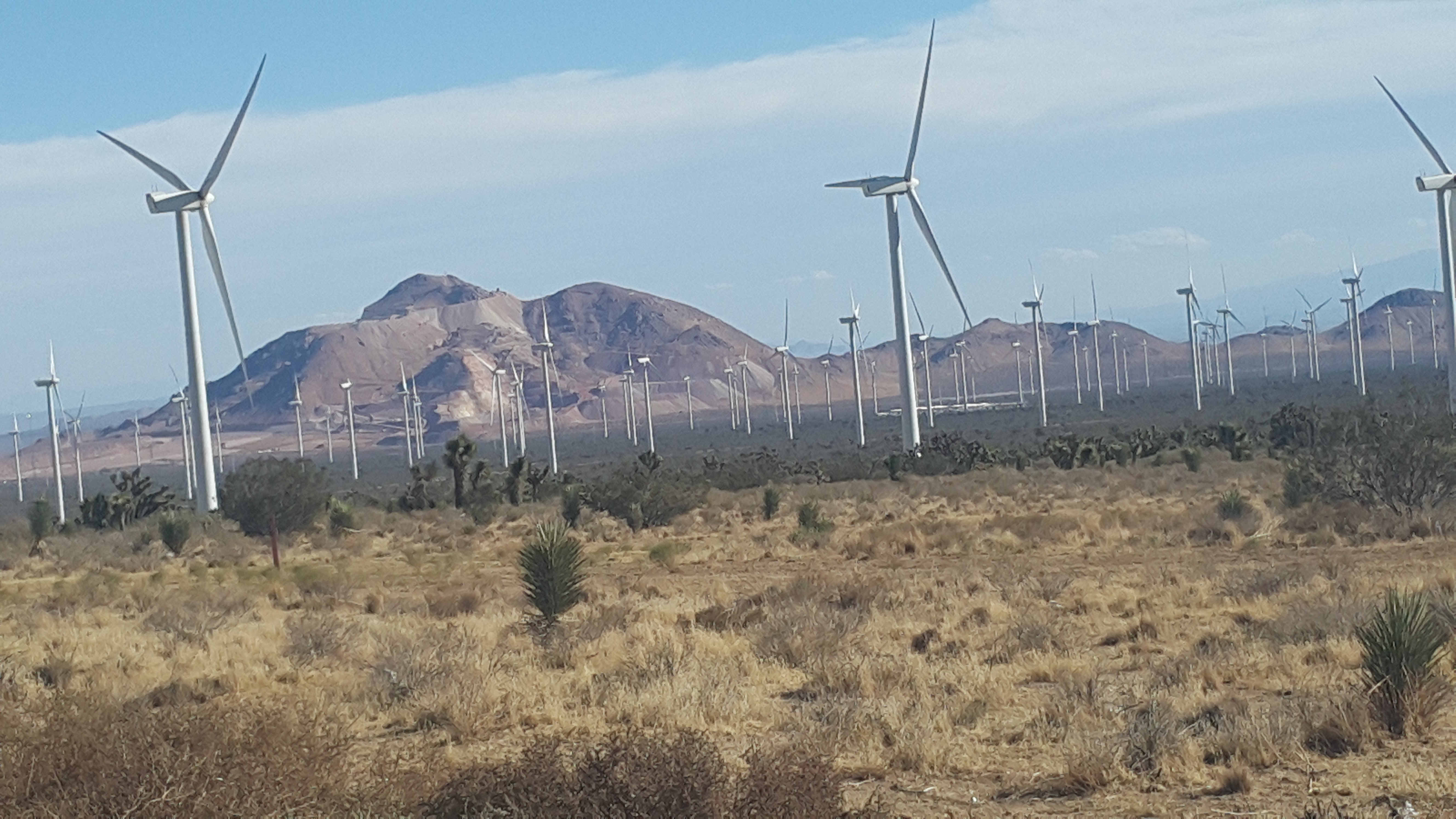 Wind turbines with desert mountains